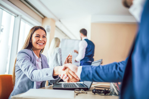 Frau im Business Outfit schüttelt Hand